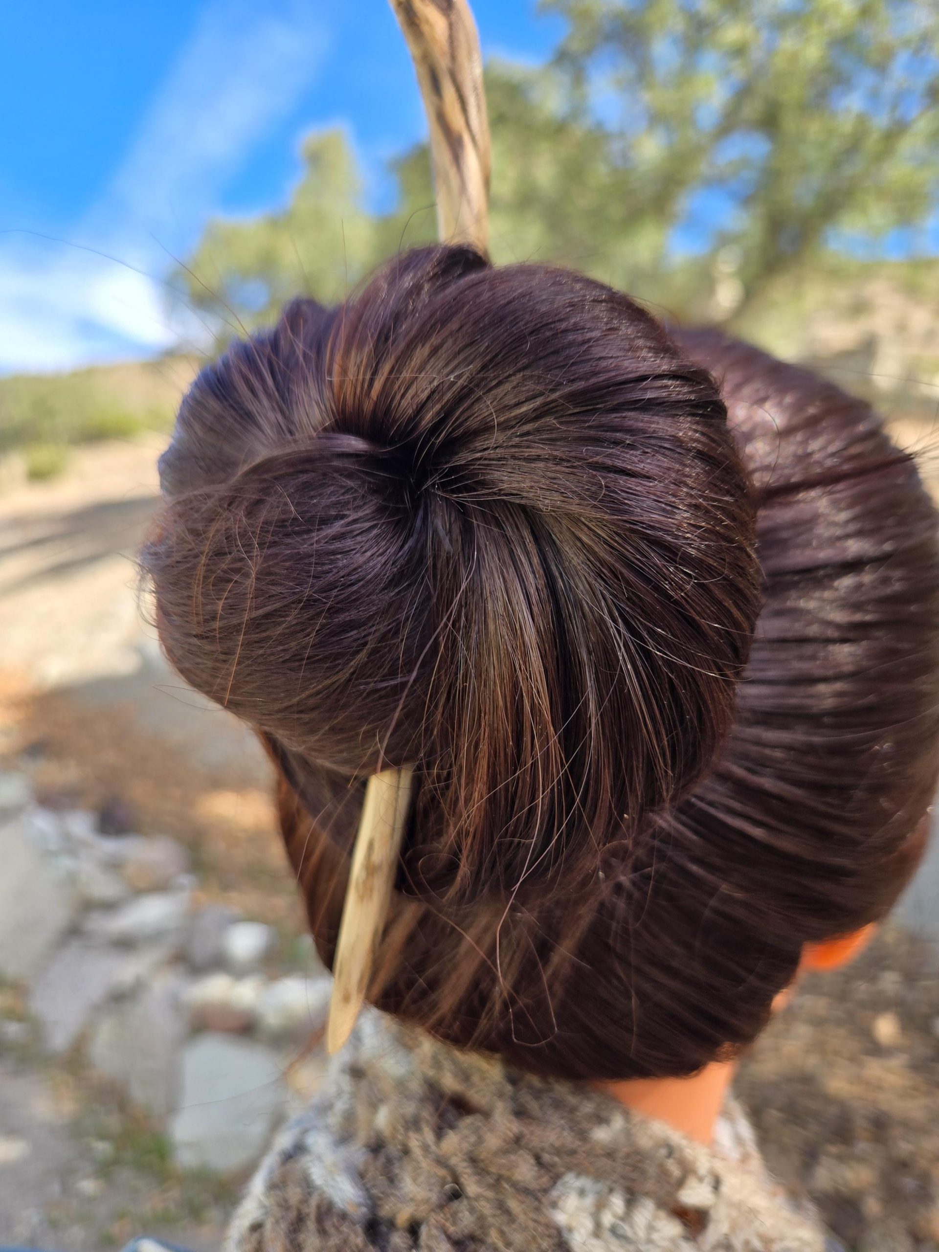Close-up of cottonwood wood grain on a handcrafted single-tine hair fork — natural materials, handmade craft.