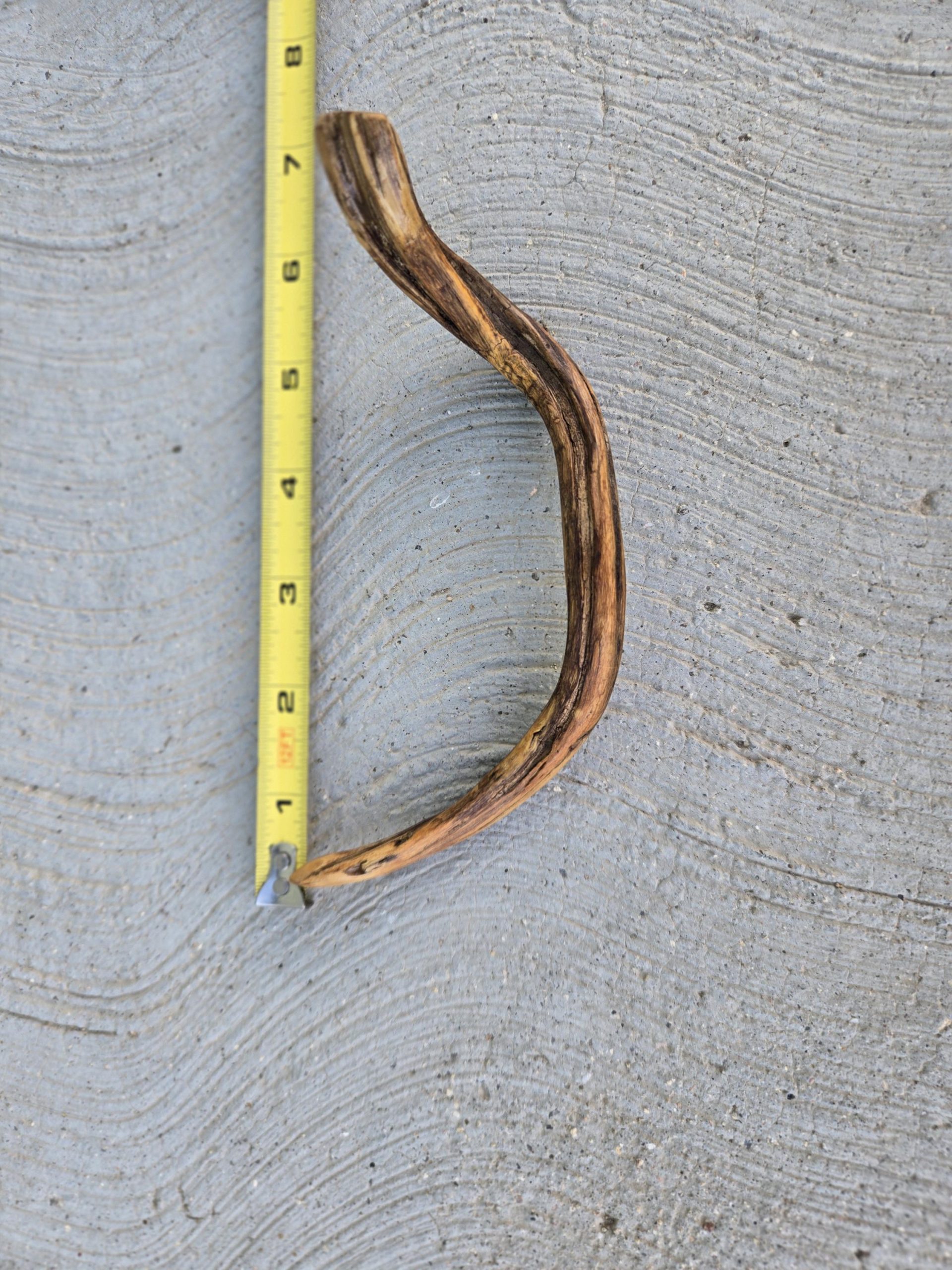 Twisted wood hair fork worn outdoors in natural light — sustainable beauty without plastic.